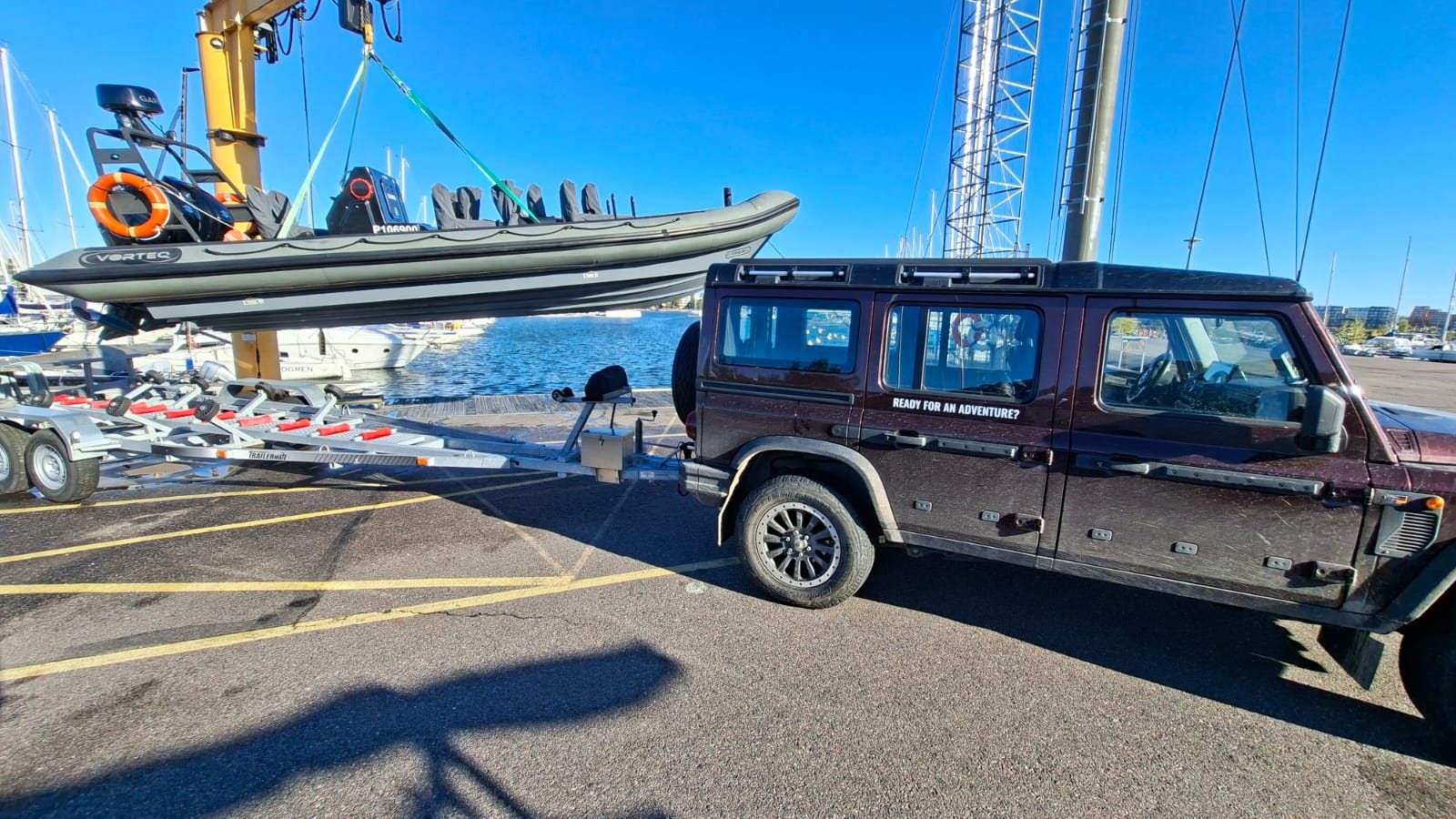 Vorteq RIB lifted by crane at the marina, next to the C-Trek truck
